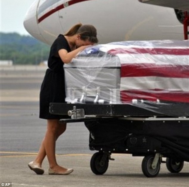 https://www.dailymail.co.uk/news/article-2139802/Portrait-widows-grief-Wife-fallen-U-S-soldier-weeps-coffin-arrives-Tennessee.html

Here, Ashley Edens collapses on the coffin of her 22-year-old husband, Army Spc. Jason K. Edens, as his body arrives in Nashville, Tennessee from service in Afghanistan.

Portrait of a widow's grief: Wife of fallen U.S. soldier weeps as she clings to his coffin as it arrives back in Tennessee
By DAILY MAIL REPORTER

PUBLISHED: 19:25 EDT, 4 May 2012 | UPDATED: 20:22 EDT, 4 May 2012